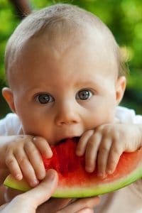Baby eating a watermelon