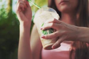 Woman holding expensive Starbucks drink