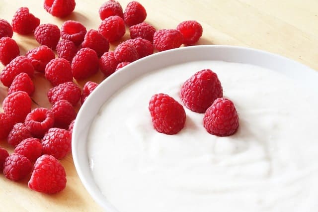 Raw milk yogurt with raspberries on top