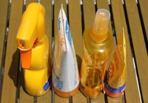 Various forms of sunscreen in lotions and spray bottles