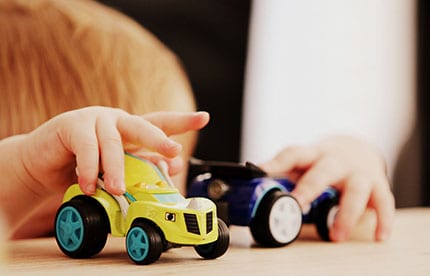 A child playing with cars