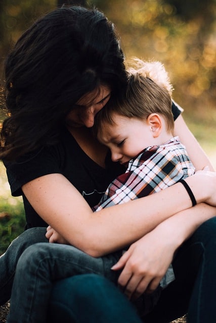 Mother holding son in her lap and connecting