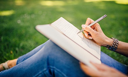 person writing in a journal