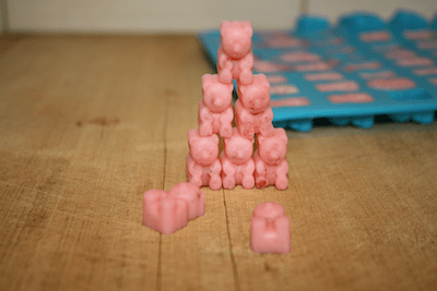 Pink gummy bears on a wooden cutting board