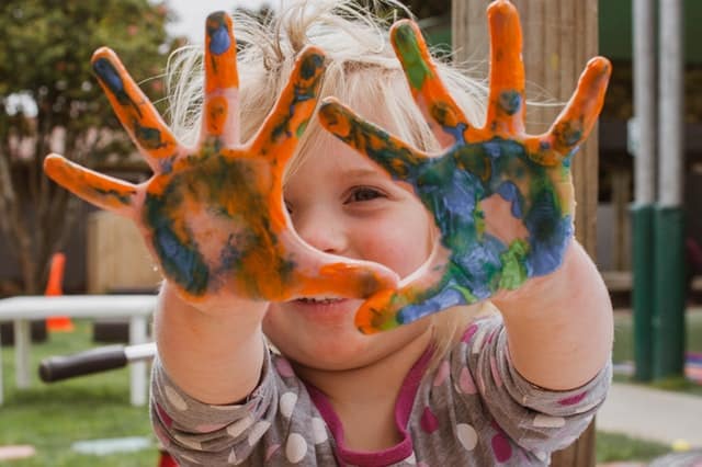 toddler with painted hands