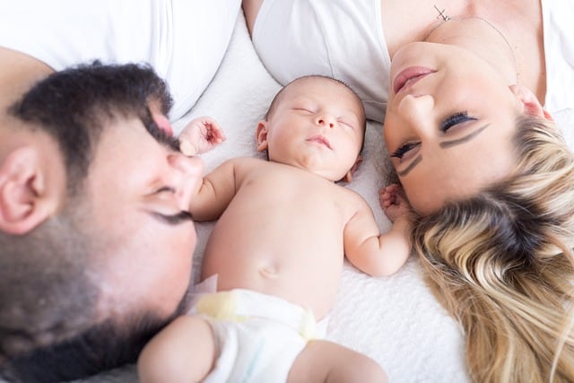 Parents cuddling their newborn baby