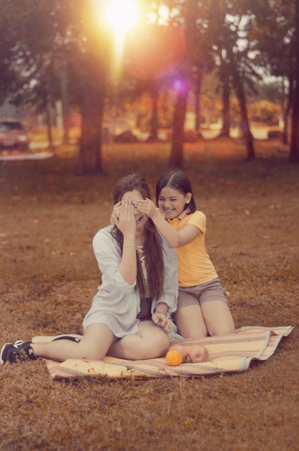 child covering mom's eyes