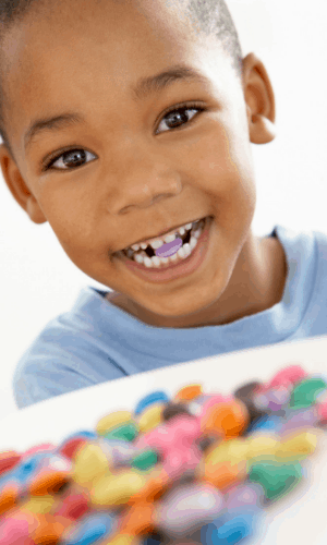 Child eating colourful candy