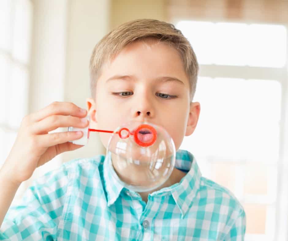 Boy blowing bubbles