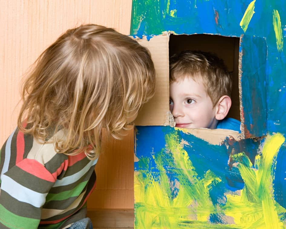 Two boys playing in a box